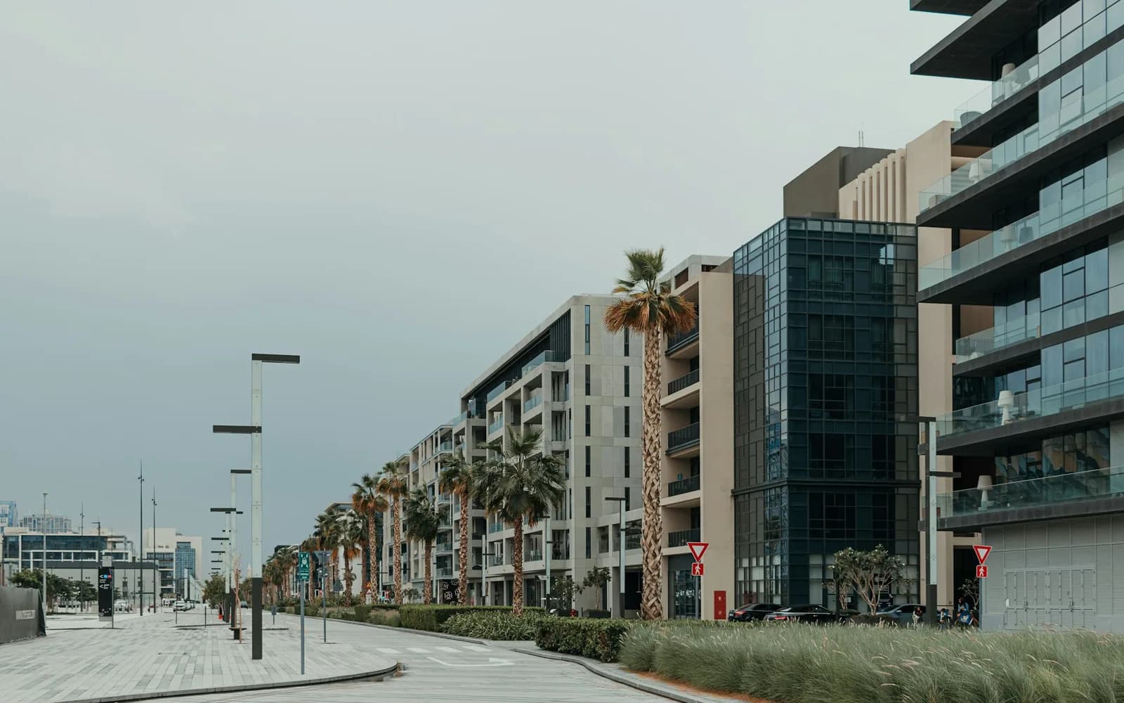Modern low-rise apartment buildings along a quiet Dubai street