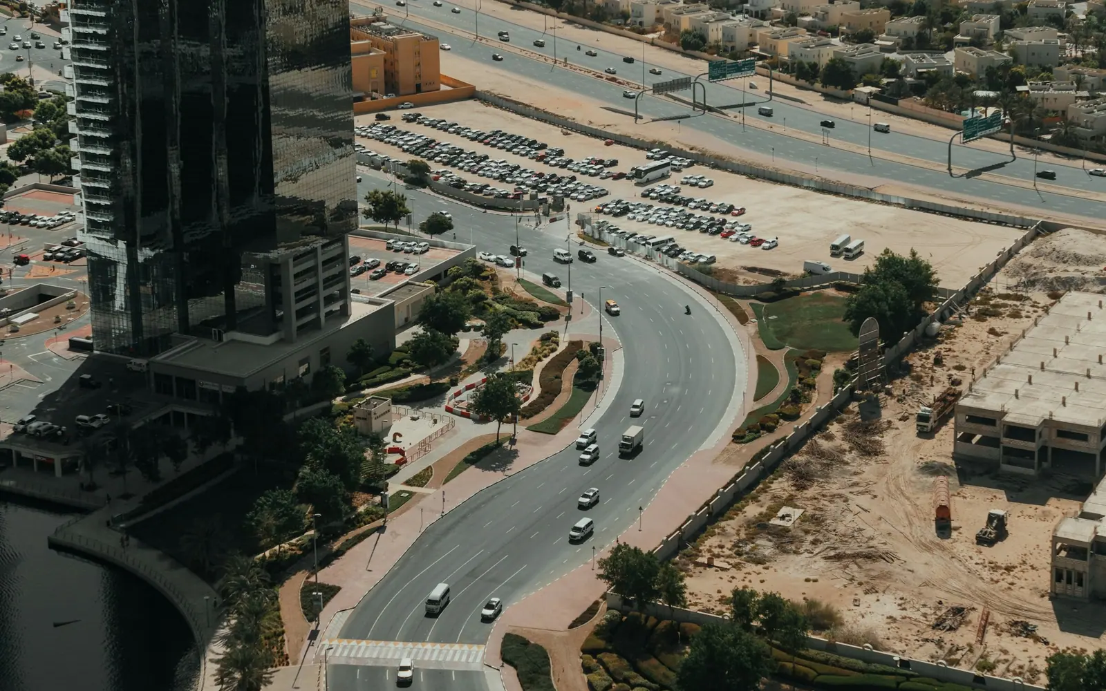 Aerial view of a newer Dubai community with towers and roads