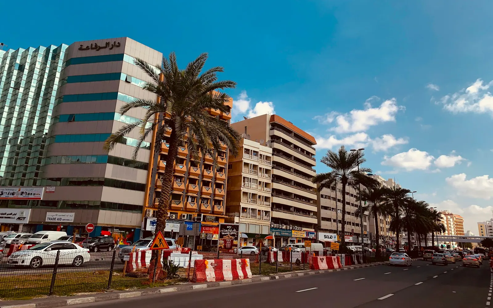 Mid-rise apartment blocks along a busy Dubai street