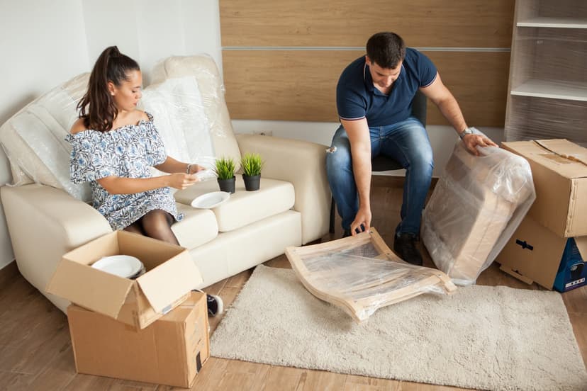 Couple packing and preparing residential furniture for moving and disposal in Dubai